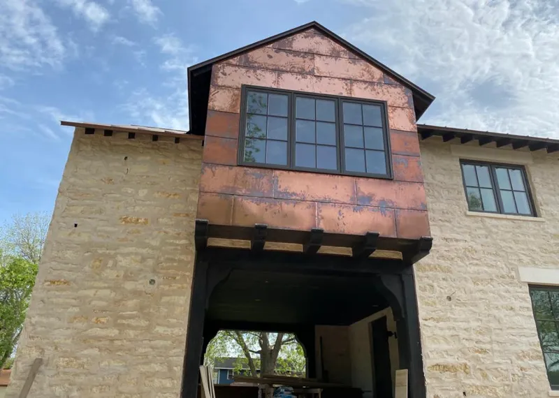 Copper metal panel facade on a stone building for Metal Roof Coating in Avon